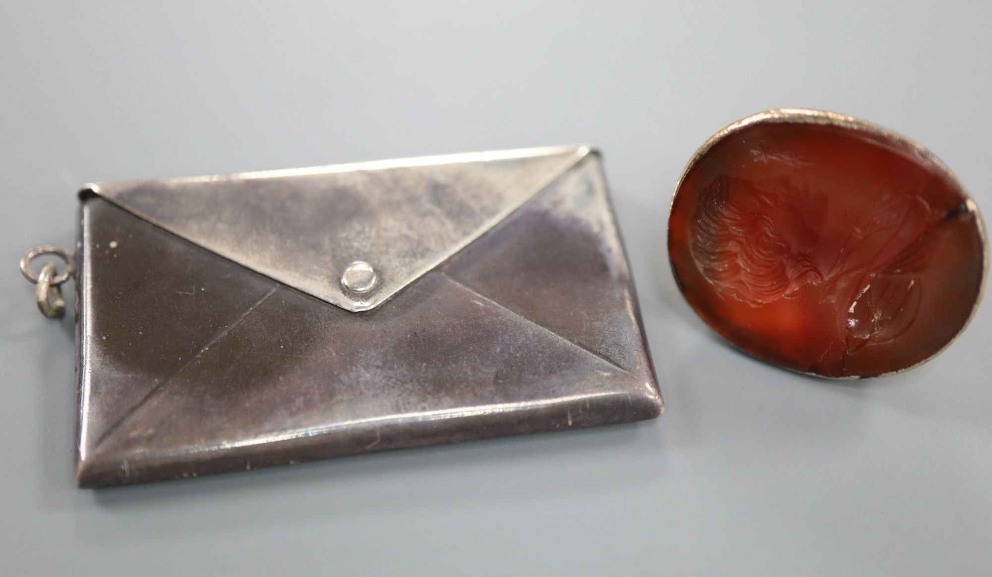 A 19th century yellow metal and carnelian set intaglio fob seal(a.f.) and an Edwardian silver double stamp case